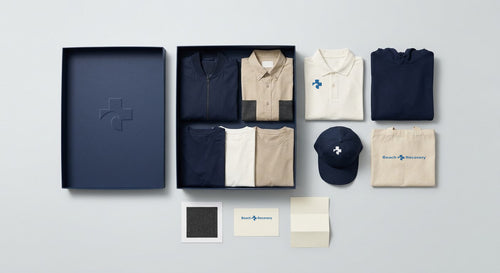 The navy six-panel cap shown with the full Founder Kit contents laid out.